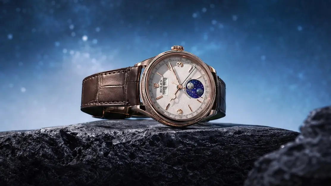 Rolex Perpetual Padellone in Everose gold on a brown leather strap, resting on dark rock under a starry sky